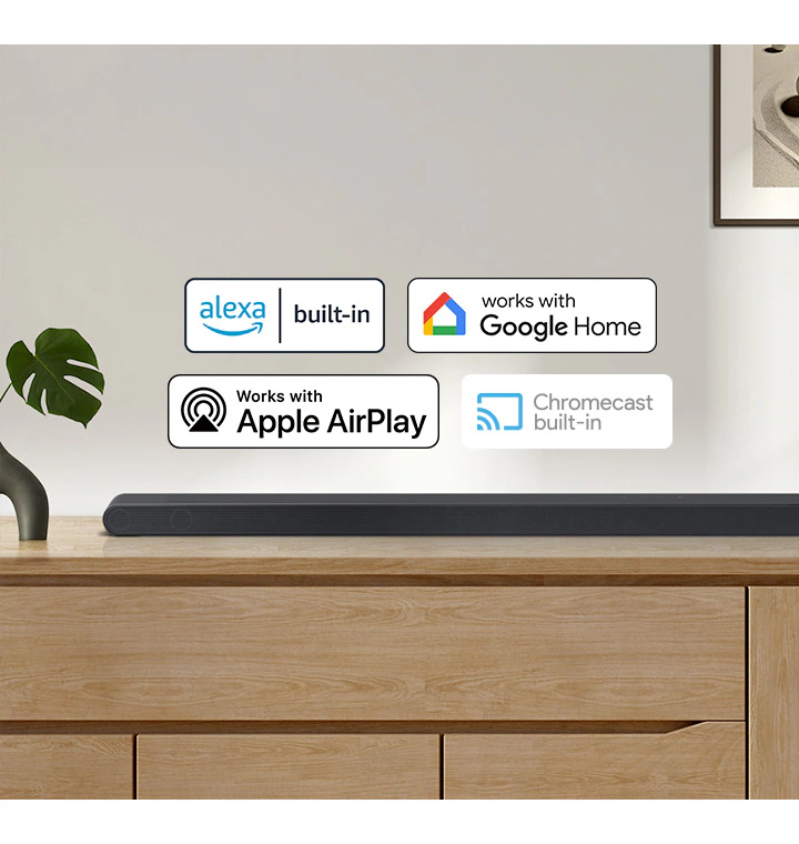 A Samsung Soundbar with logos for Alexa built-in, Works with Google Home, Works with Apple AirPlay and Chromecast built-in.