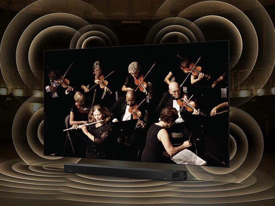 Simulated sound wave graphics from TV and soundbar demonstrate Q Symphony technology as they play sound together.