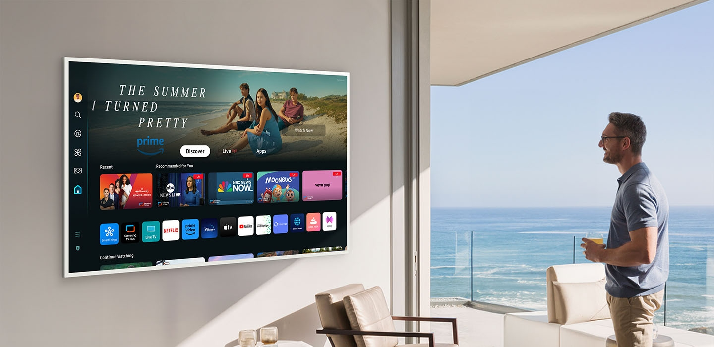 A man is looking at various entertainment options offered on Samsung Tizen OS on The Frame TV.