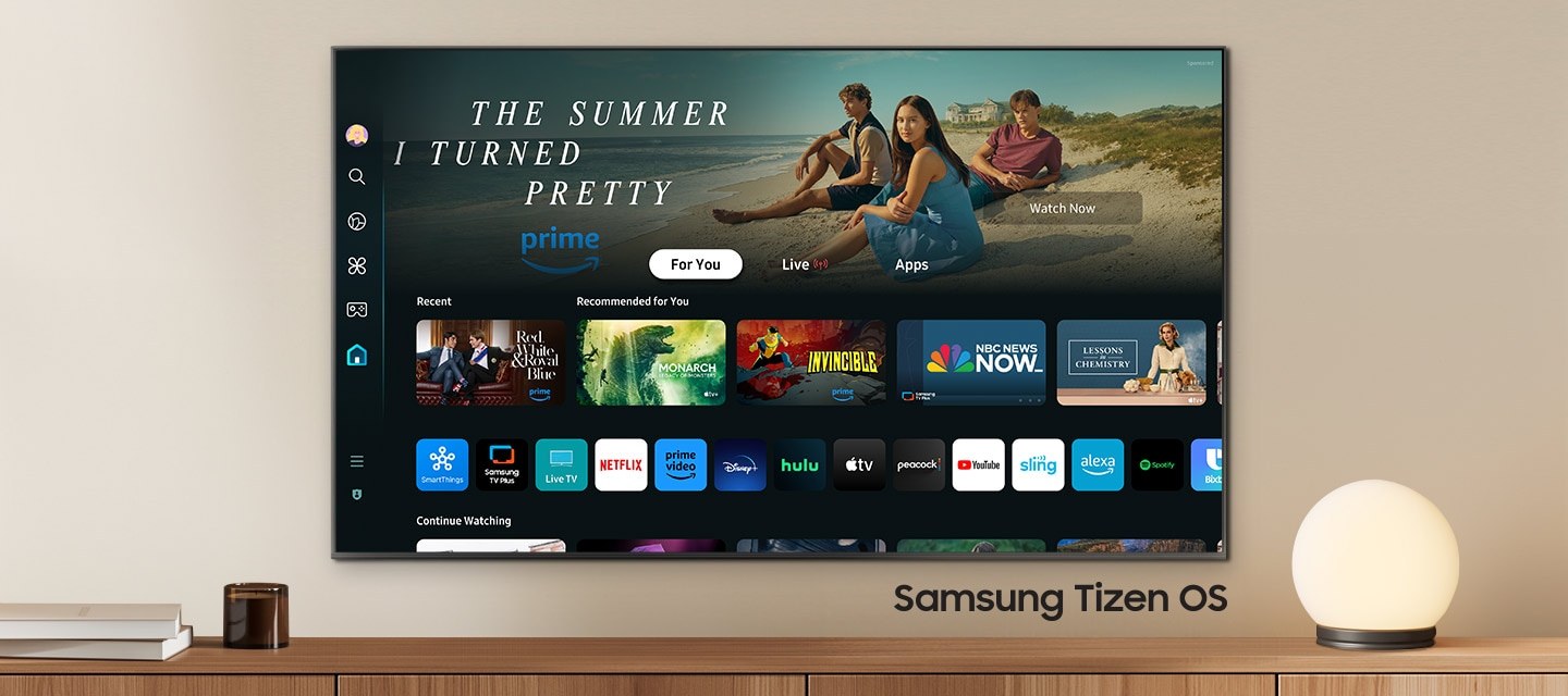 A wall-mounted TV shows popular apps and curated content on the home menu. "Samsung Tizen OS"